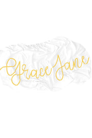 Woolf With Me Organic Personalized Fitted Crib Sheet Cursive Large Centered color_primrose-yellow