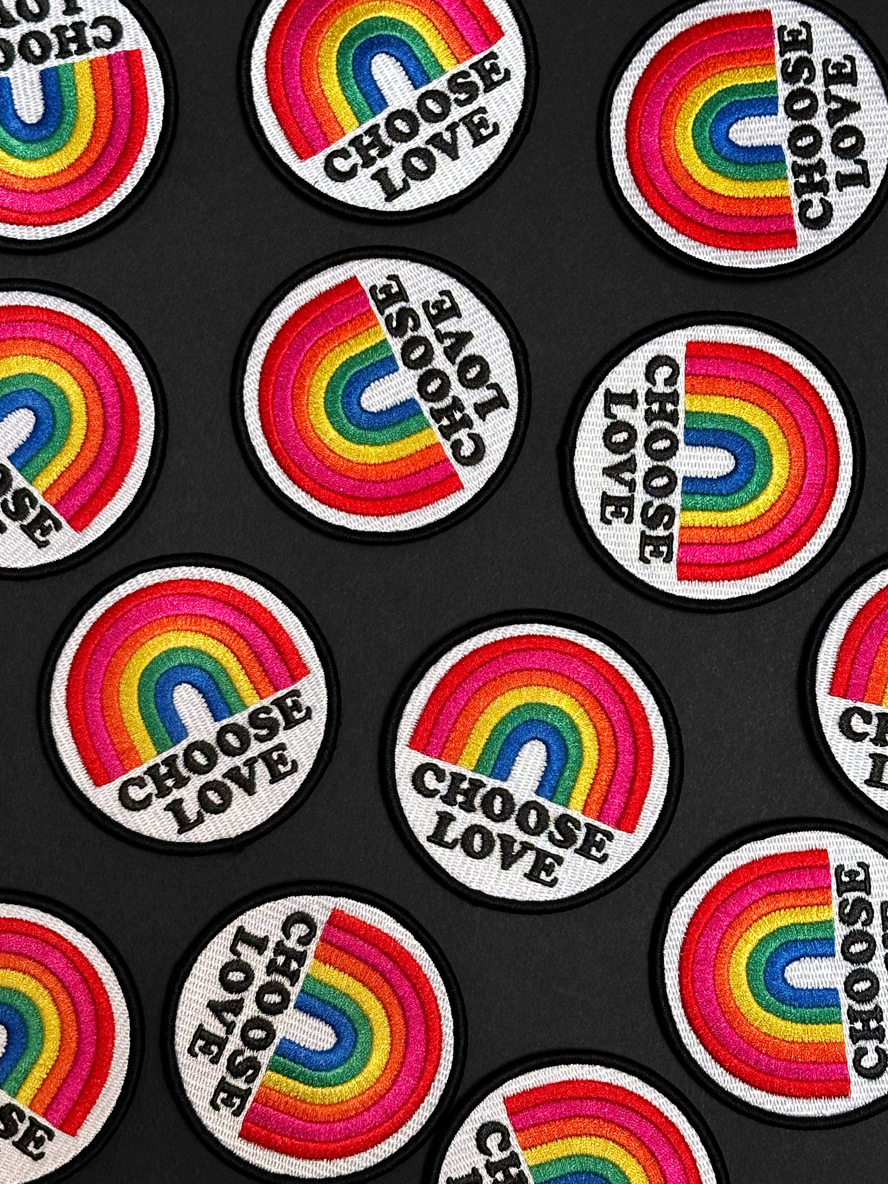 Patches with rainbow designs and 'Choose Love' text on a black background