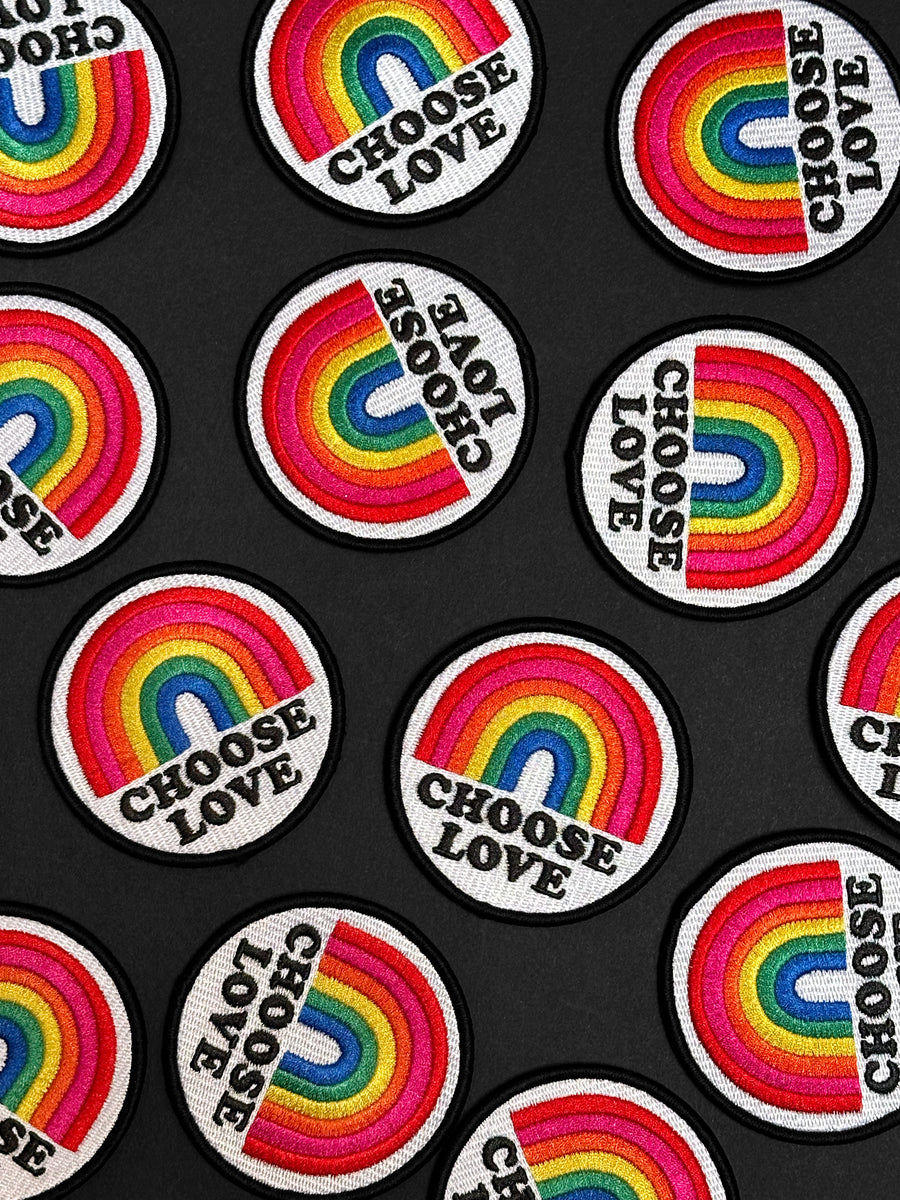 Patches with rainbow designs and 'Choose Love' text on a black background