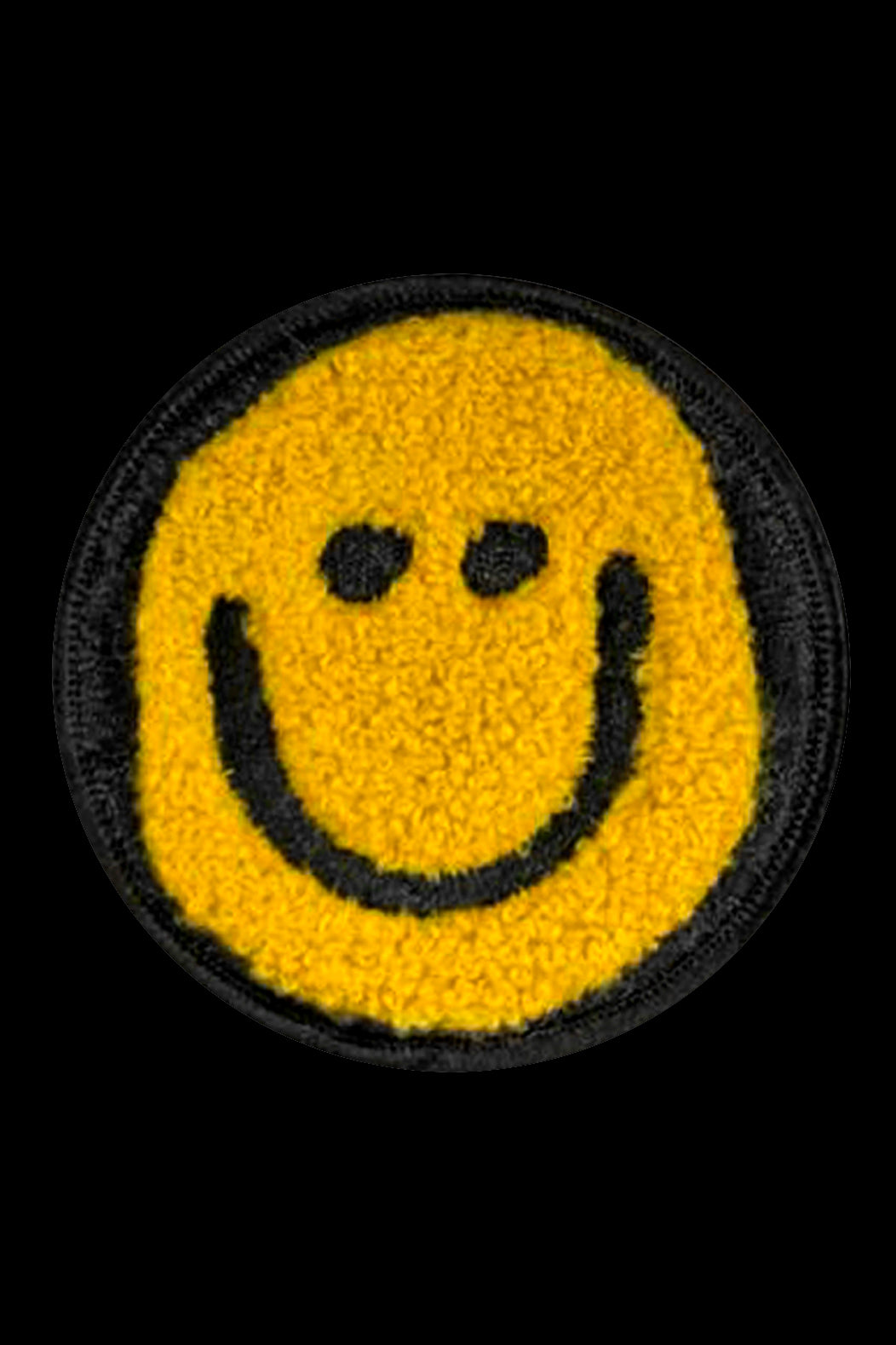 Smiley face patch with yellow background and black outline on a black background