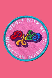 Embroidered patch with 'Pride' text on a pink background