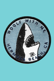 Shark patch with text on a teal background