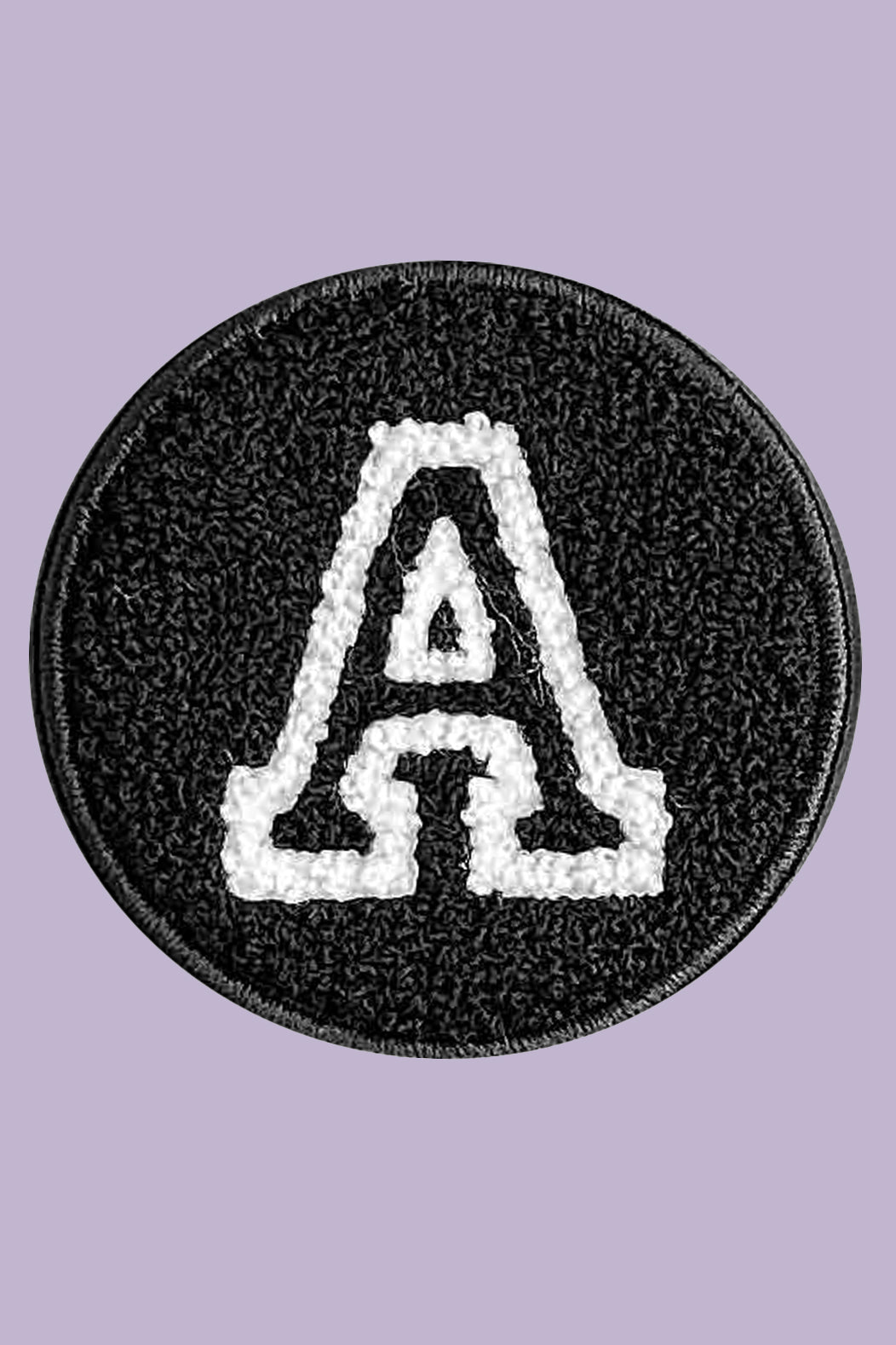 Black round patch with white letter 'A' on a purple background