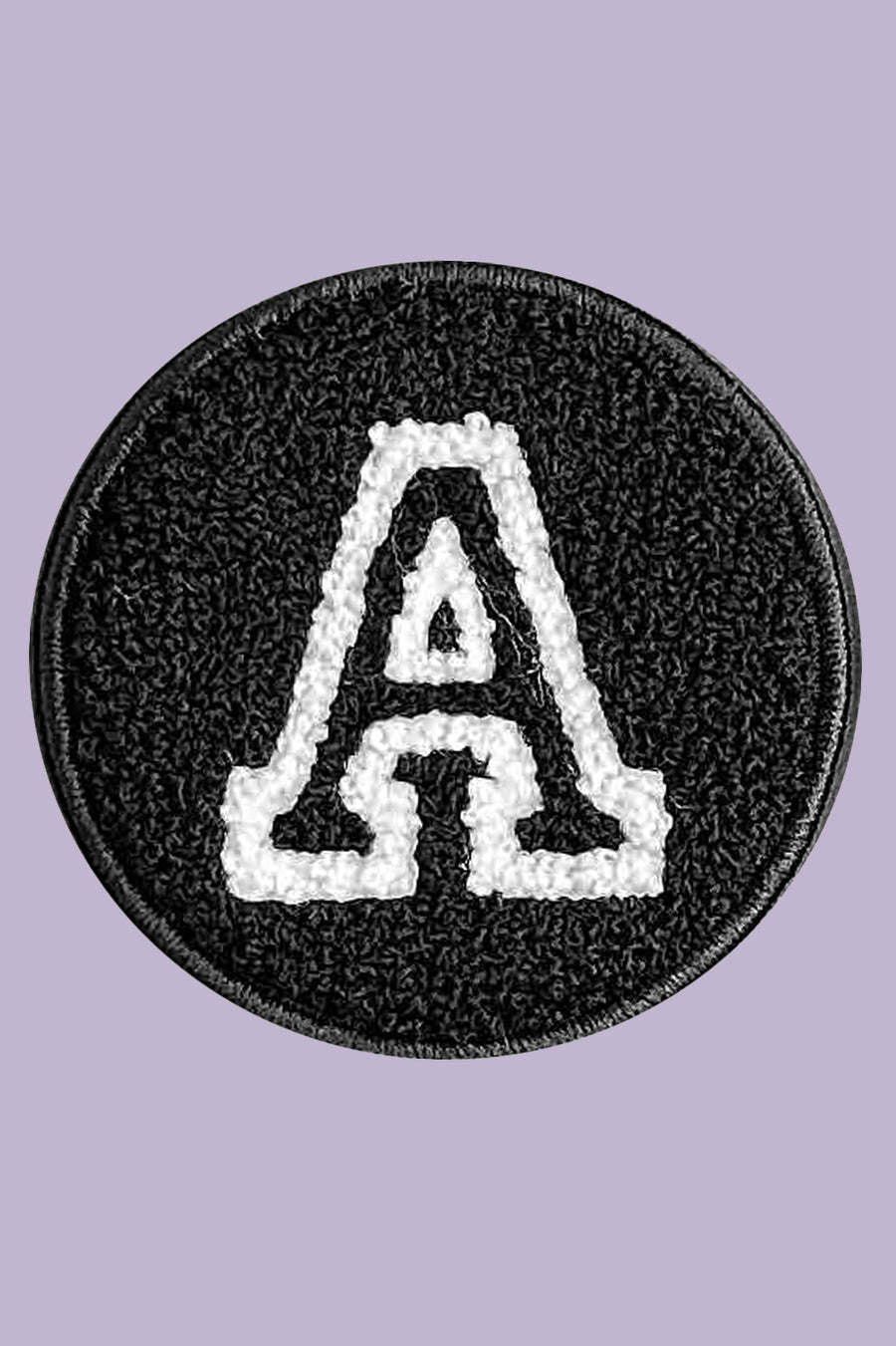 Black round patch with white letter 'A' on a purple background