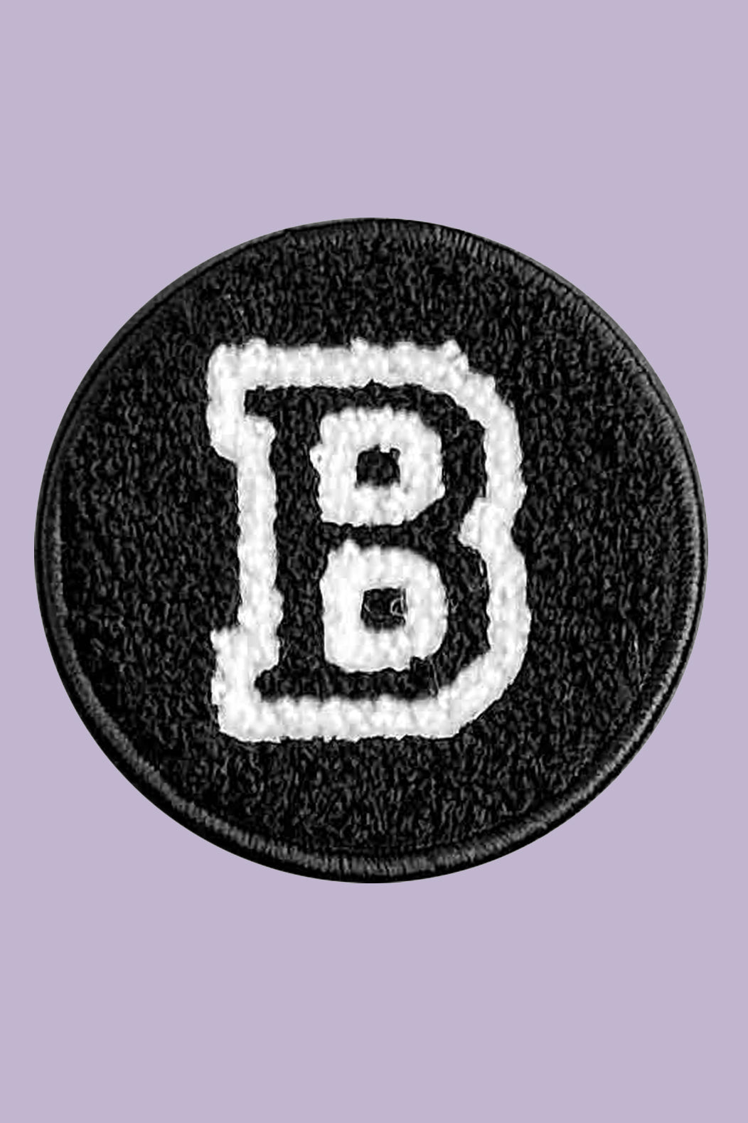 Black patch with white letter 'B' on a purple background