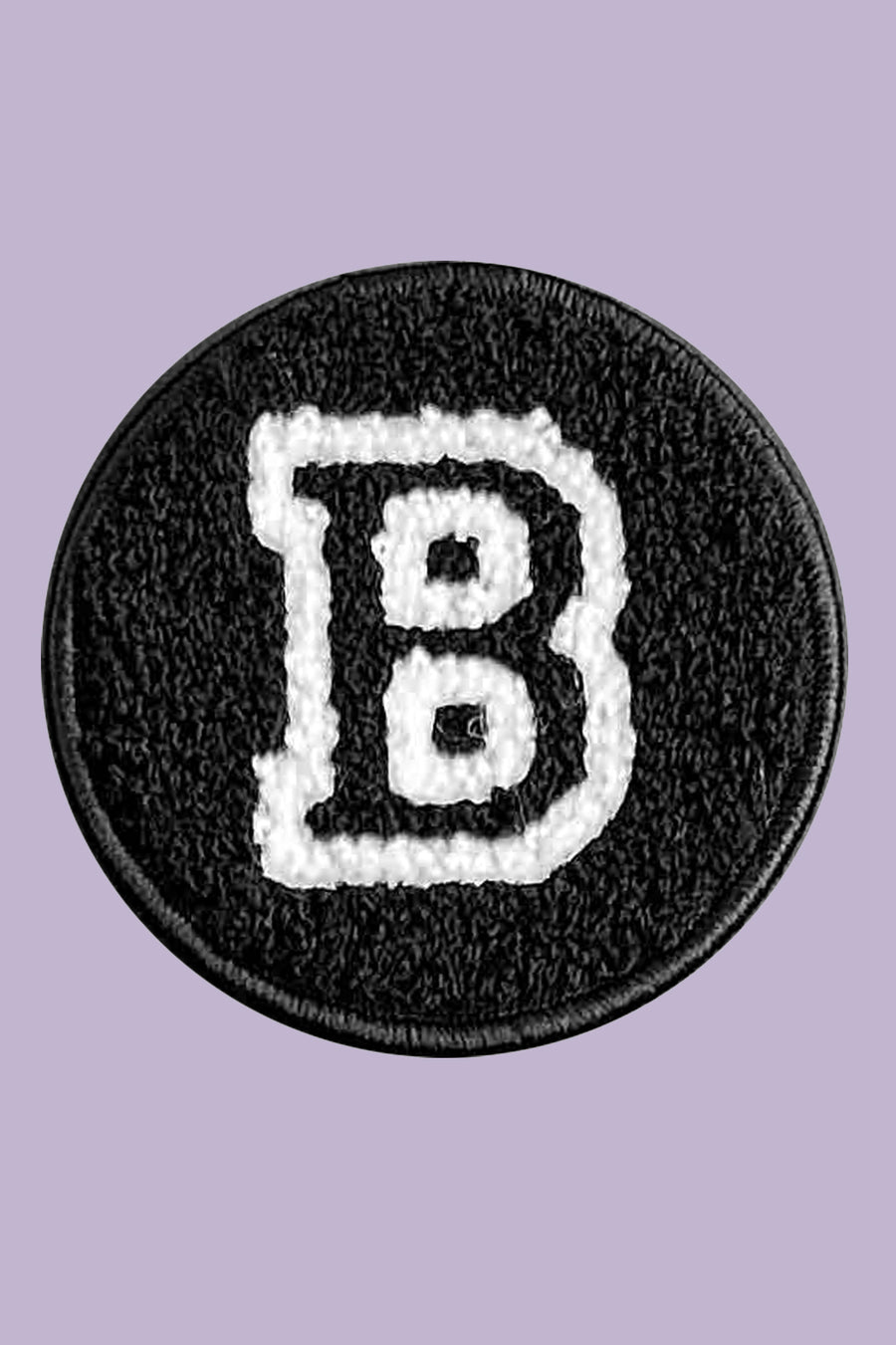 Black patch with white letter 'B' on a purple background