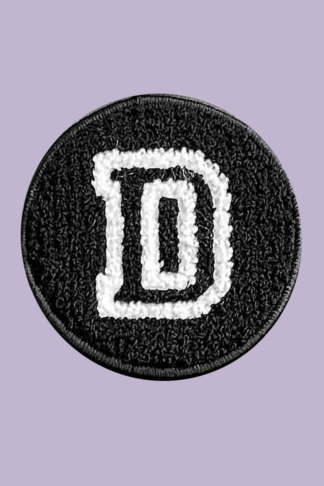 Black patch with white letter 'D' on a purple background