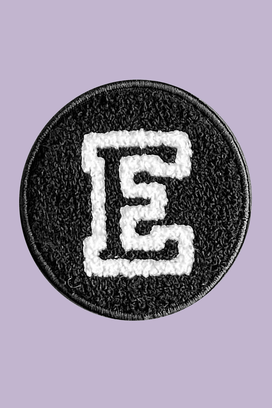 Circular patch with letter 'E' on a purple background