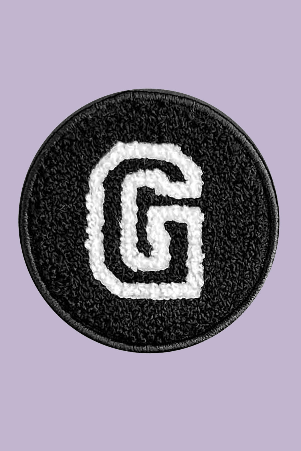 Circular patch with letter 'G' on a purple background