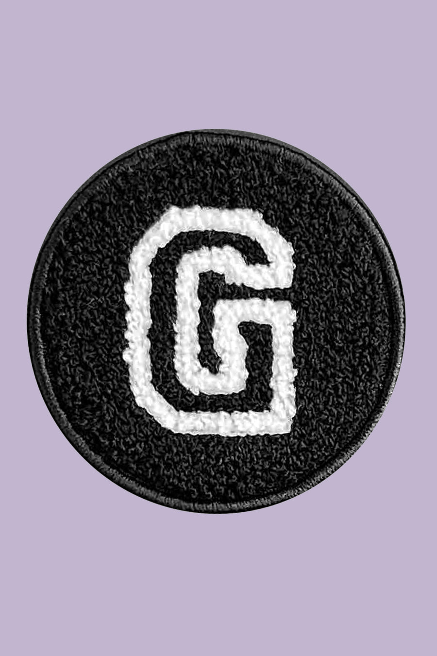 Circular patch with letter 'G' on a purple background