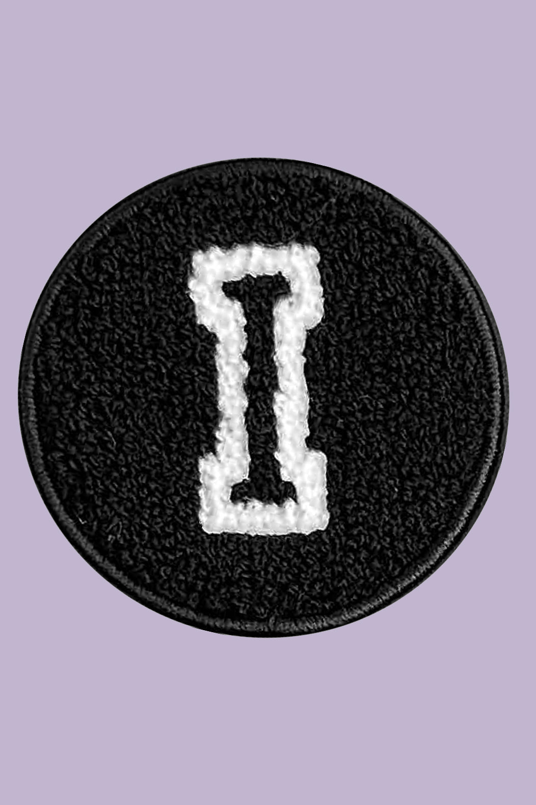 Black circular patch with a white letter 'I' on a purple background