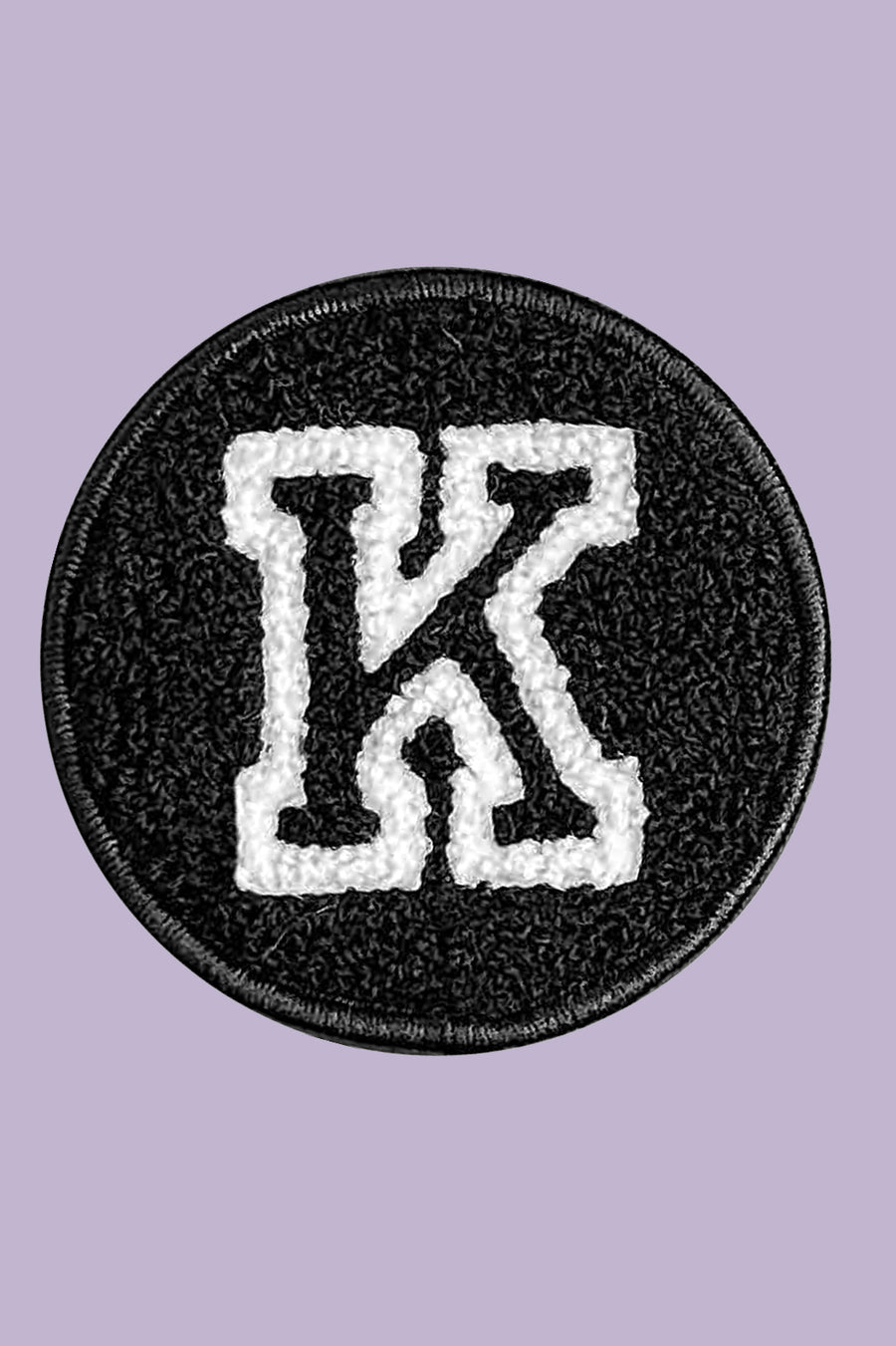 Black patch with white letter 'K' on a purple background