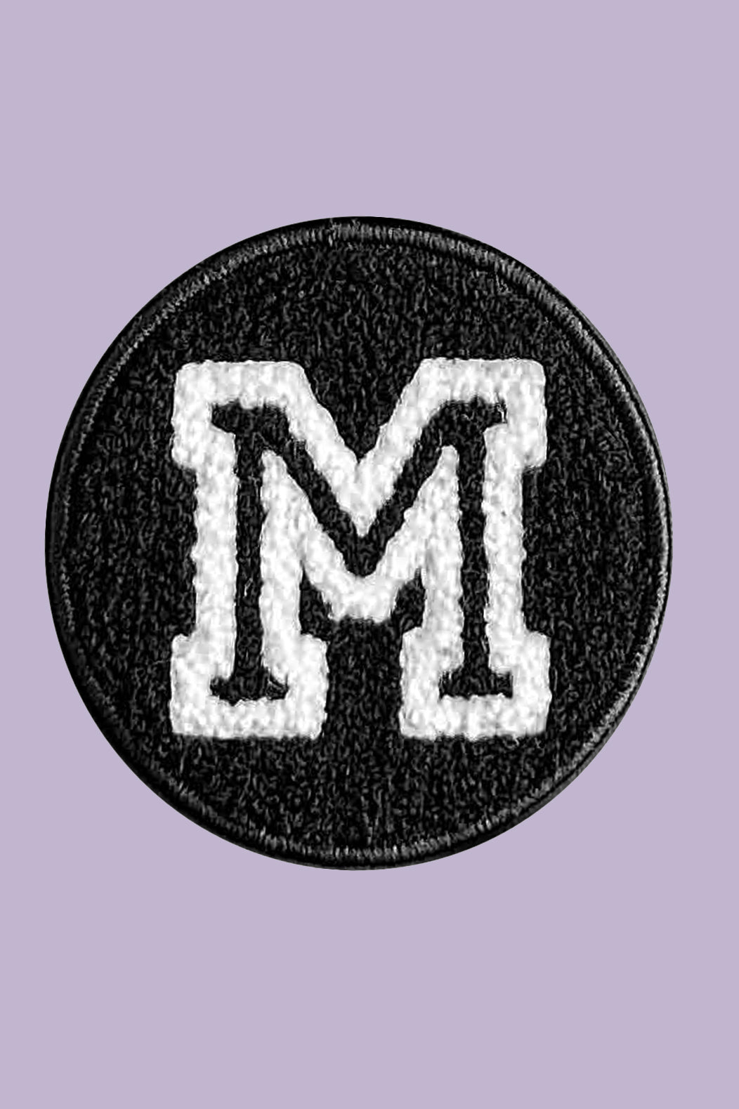 Black patch with white letter 'M' on a purple background
