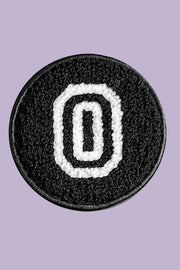 Black patch with white letter 'O' on a purple background