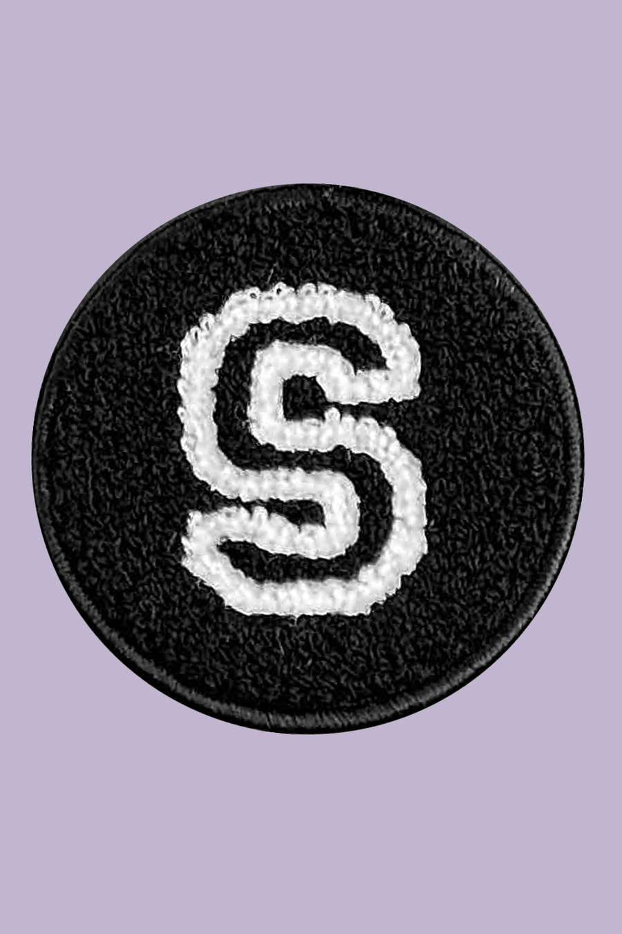 Black round patch with white letter 'S' on a purple background