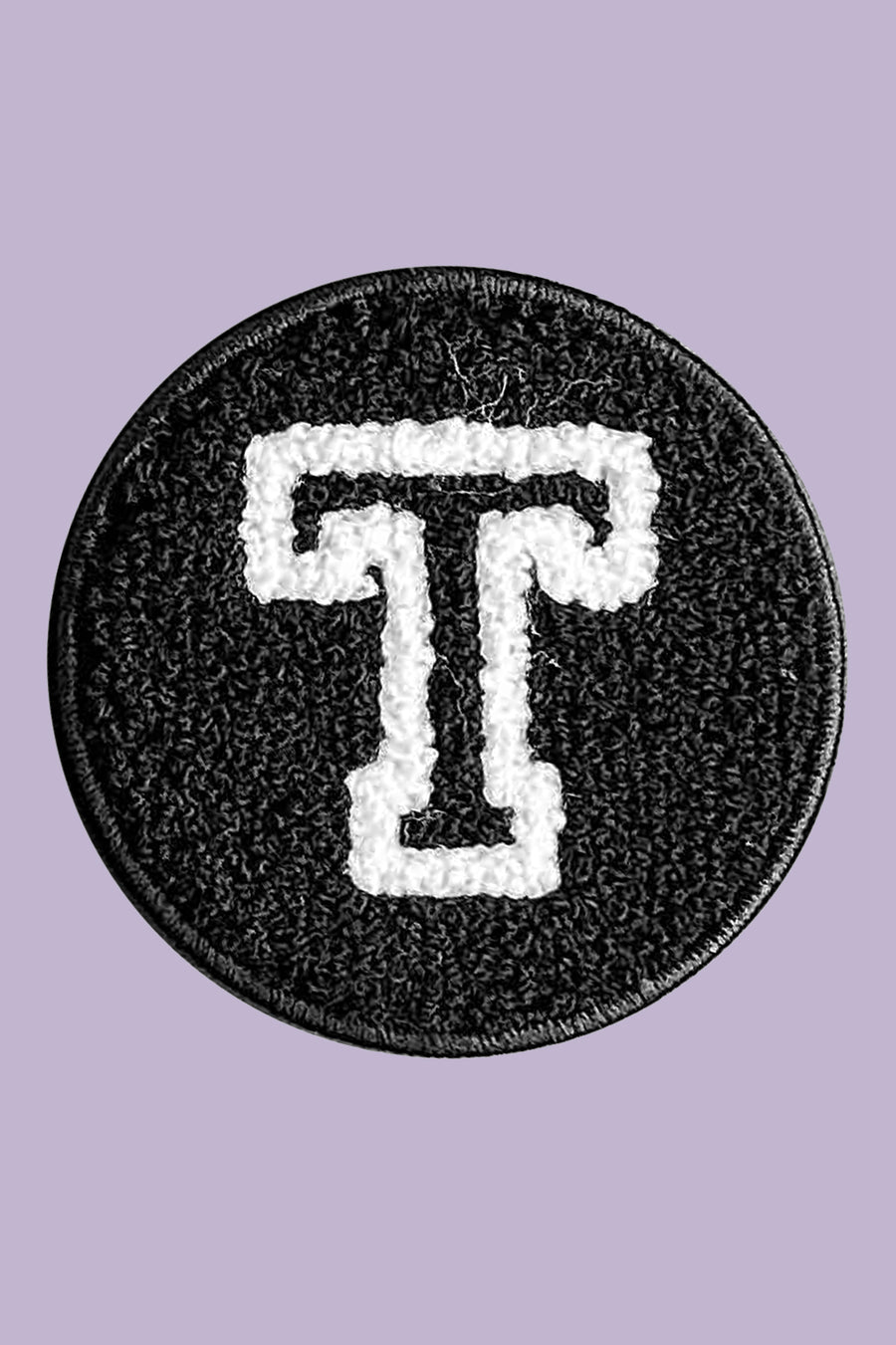 Black patch with white letter 'T' on a purple background
