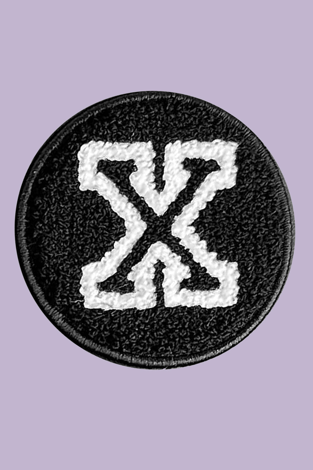 Black and white patch with a symbol on a purple background