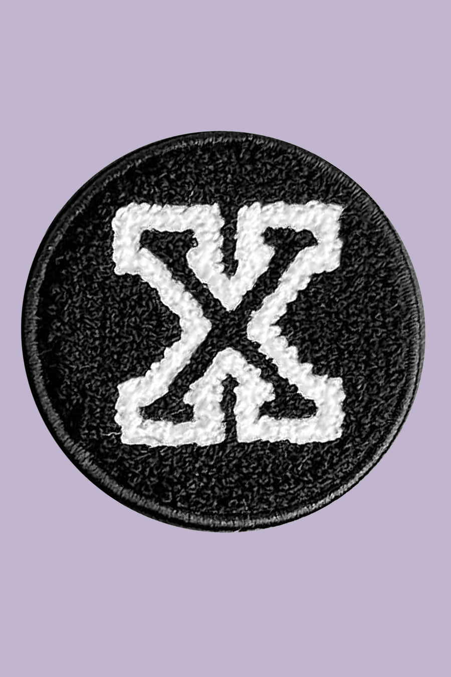 Black and white patch with a symbol on a purple background