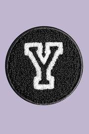Black patch with white letter 'Y' on a purple background