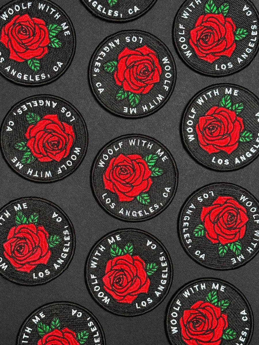 Multiple patches with red roses and text on a black background