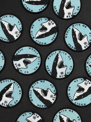 Pattern of shark illustrations with text on a black background