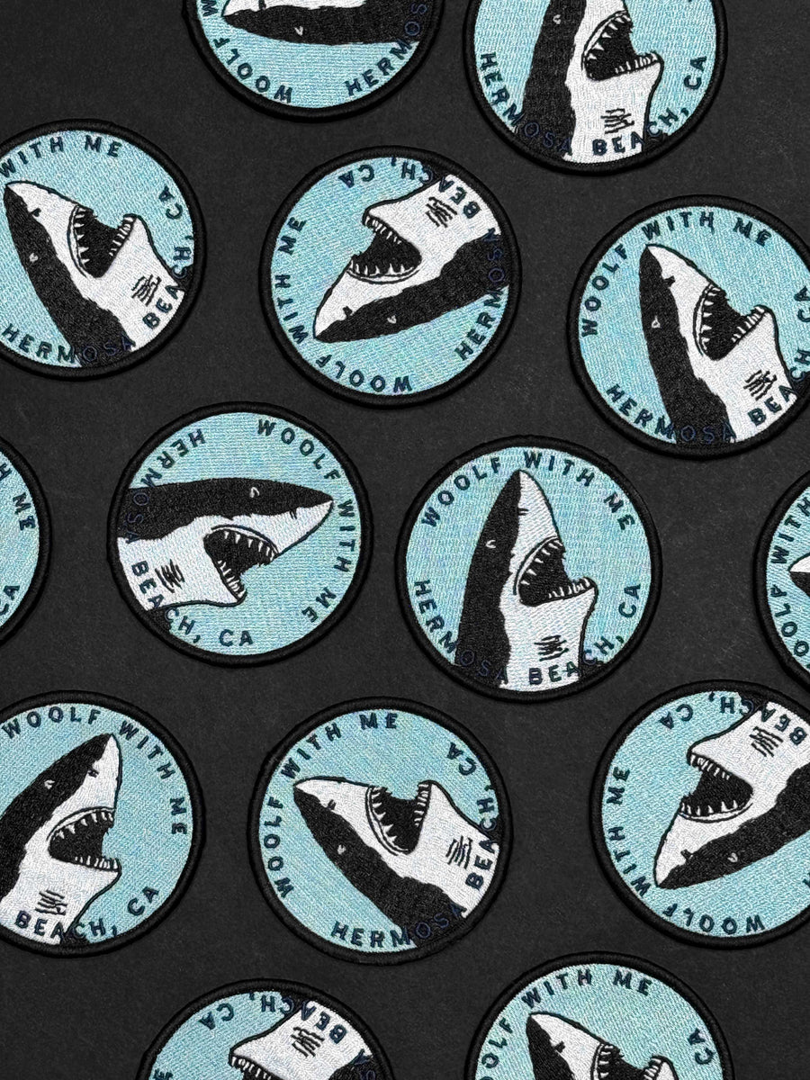Pattern of shark illustrations with text on a black background