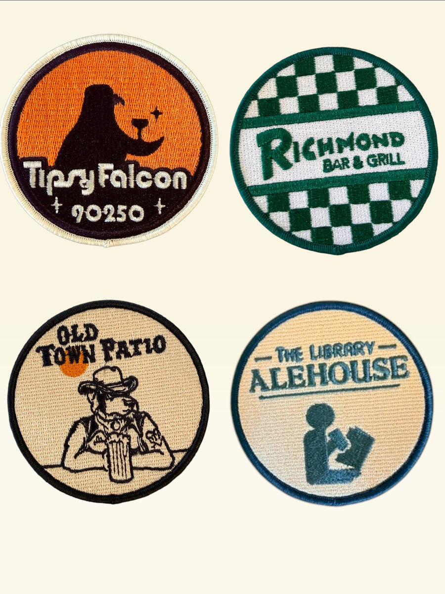 Woolf With Me® custom circular embroidered Velcro patch featuring an orange background and Tipsy Falcon logo.
