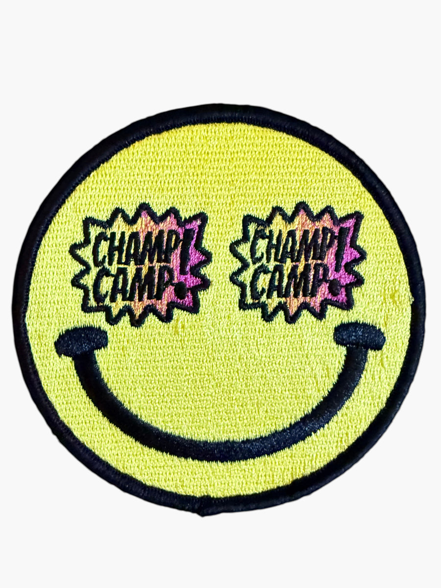 Woolf With Me® round yellow embroidered smiley face patch with Champ Camp text in star-shaped sunglasses