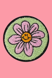 Flower patch with smiley face on a pink background